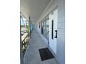 Exterior shot of condo featuring a white front door with welcome mat and a lengthy sidewalk at 5860 43Rd N Ter # 1518, Kenneth City, FL 33709