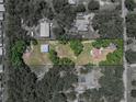Aerial view showcasing the property layout, including the main house and a detached garage at 5926 Frontier Dr, Zephyrhills, FL 33540