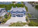 Waterfront home featuring multiple garages, a boat dock, and a large driveway at 601 2Nd St, Indian Rocks Beach, FL 33785