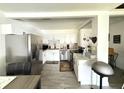 Bright kitchen featuring stainless steel appliances, white cabinetry, and a decorative backsplash at 6426 S Himes Ave, Tampa, FL 33611