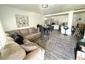 Open-concept living area with a comfortable sectional sofa and adjacent modern kitchen at 6426 S Himes Ave, Tampa, FL 33611