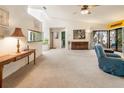 Bright living room with vaulted ceilings, neutral carpet, and sliding glass doors to an outdoor patio at 70 Morning Dove Pl, Oldsmar, FL 34677