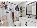 Stylish bathroom featuring a modern shower curtain and black hardware at 801 Kirkcaldy Way, Valrico, FL 33594