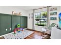 Bright, inviting bedroom with wood floors and a name art piece at 801 Kirkcaldy Way, Valrico, FL 33594