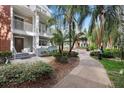 Beautifully landscaped courtyard with mature trees, a water feature, and inviting walkways at 834 N Oregon Ave, Tampa, FL 33606