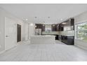 Modern kitchen featuring stainless steel appliances, a center island, and stylish pendant lighting at 834 N Oregon Ave, Tampa, FL 33606