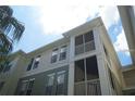 Three-story condo with screened balconies and white railing at 9320 Crescent Loop Cir # 304, Tampa, FL 33619