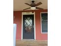 A close-up of the front door with a decorative window and the house number above at 9907 Maggie St, Gibsonton, FL 33534