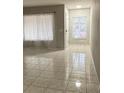 Well-lit living room boasting tile flooring, windows, and neutral paint at 10823 Brickside Ct, Riverview, FL 33579