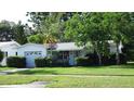 A well-landscaped single-story home with an attached garage and cozy curb appeal at 10871 86Th Ave, Seminole, FL 33772