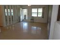Bright living room with terrazzo floors and ample natural light, featuring mirrored wall decor at 10871 86Th Ave, Seminole, FL 33772