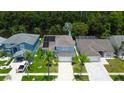 Aerial view of home with solar panels, lush landscaping, and a well-maintained lawn at 11121 Clayridge Dr, Tampa, FL 33635