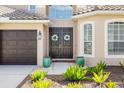 Elegant double front doors with decorative wreaths, complemented by lush greenery at 1178 Fraser Pine Blvd, Sarasota, FL 34240