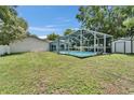 View of the sparkling, screened-in pool, offering a serene backyard oasis at 1207 Oak Valley Dr, Seffner, FL 33584