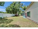 Expansive backyard featuring a white fence, manicured lawn, and plenty of space for outdoor activities at 1207 Oak Valley Dr, Seffner, FL 33584