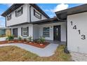 The front of the home features a well-maintained yard and walkway, leading to an inviting entryway at 1413 E 108Th Ave, Tampa, FL 33612
