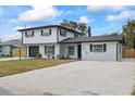 Charming home with a gravel driveway, complemented by fresh exterior paint and new landscaping elements at 1413 E 108Th Ave, Tampa, FL 33612