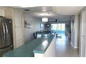 Bright kitchen featuring stainless steel appliances, breakfast bar, and an open view to the living area at 1847 Shore Drive S # 415, South Pasadena, FL 33707