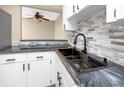 Modern kitchen with white cabinets, dark hardware, designer countertops, and stainless steel sink at 1881 Lichen Ln # B, Clearwater, FL 33760