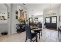 Elegant dining area featuring decorative wall art, and stylish chandelier at 19104 Cellini Pl, Lutz, FL 33558