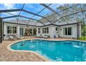 Enjoy this screened-in pool with an attached spa, outdoor lounge and dining area perfect for relaxing and entertaining at 2435 Fox Forest Dr, Lutz, FL 33549