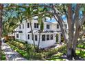 Beautiful two-story home featuring a green door and mature tropical landscaping at 258 14Th Ne Ave, St Petersburg, FL 33701