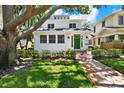 Charming two-story home featuring a green door, and manicured landscaping at 258 14Th Ne Ave, St Petersburg, FL 33701