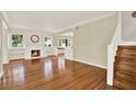 Bright living room with hardwood floors, a fireplace, and large windows at 258 14Th Ne Ave, St Petersburg, FL 33701