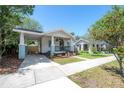 Comfortable single story home with a front porch and carport with driveway, offering convenience at 318 W Haya St, Tampa, FL 33603