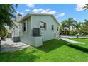 Exterior of home with a hammock and pool in a lush, green backyard at 338 7Th N Ave, Tierra Verde, FL 33715