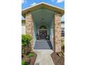 Inviting front porch with double doors, decorated with wreaths, and rocking chairs at 338 7Th N Ave, Tierra Verde, FL 33715