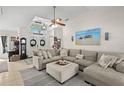 Open-concept living room with vaulted ceiling, cozy furniture, and lots of natural light at 338 7Th N Ave, Tierra Verde, FL 33715