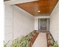 Inviting entryway with a modern front door and stylish wood-paneled ceiling at 3408 W Swann Ave, Tampa, FL 33609