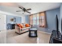 Cozy living room with tile floors, ceiling fan, and neutral-toned sofa at 3818 Beechwood Dr, Holiday, FL 34691