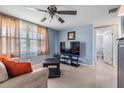 Comfortable living room featuring a ceiling fan and a large window for natural light at 3818 Beechwood Dr, Holiday, FL 34691