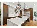 Spacious kitchen with island, marble countertops, stainless steel appliances, and stylish pendant lighting at 443 Lucerne Ave, Tampa, FL 33606