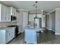 Bright kitchen featuring white cabinetry, quartz countertops, and stainless steel appliances at 4510 Big Woods Way, Parrish, FL 34219