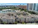 An aerial view of luxury condominiums with a glimpse of city skyline, lake and surrounding landscape at 501 Knights Run Ave # 1209, Tampa, FL 33602