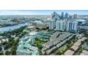 Gorgeous aerial view of luxury townhomes showcasing the community, tennis courts, and city skyline at 501 Knights Run Ave # 1209, Tampa, FL 33602