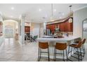 Open concept kitchen with stainless steel appliances, island, and breakfast bar at 5141 Riva Ridge Dr, Wesley Chapel, FL 33544
