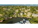 Expansive aerial view reveals the neighborhood, waterfront homes, and canal leading out to the bay at 593 Marmora Ave, Tampa, FL 33606