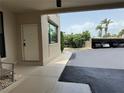Exterior view showing covered parking and entryway; palm trees in background under partly sunny sky at 750 Island Way # 101, Clearwater Beach, FL 33767