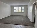 Bright living room with neutral carpet, large windows, and white walls, creating a clean and inviting atmosphere at 750 Island Way # 101, Clearwater Beach, FL 33767