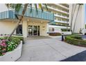 Inviting building entrance with manicured landscaping, showcasing a welcoming and well-maintained property at 7932 Sailboat Key S Blvd # 406, South Pasadena, FL 33707