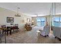 Cozy living room features water view, carpet, and comfortable seating, perfect for relaxation and entertaining at 7932 Sailboat Key S Blvd # 406, South Pasadena, FL 33707