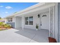 Inviting front porch with decorative metal posts and a freshly painted front door at 8030 Jasmine Blvd, Port Richey, FL 34668