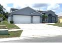 Attractive one-story home featuring a two-car garage, well-maintained lawn, and inviting front door at 11513 Andy Dr, Riverview, FL 33569