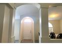 Inviting foyer featuring an arched entrance, columns, and a view into the dining area and other living spaces at 11513 Andy Dr, Riverview, FL 33569
