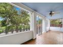 Relaxing screened porch with ceiling fan and swing, perfect for enjoying the outdoors at 1400 Cherry Ne St, St Petersburg, FL 33704