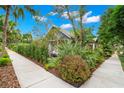 Landscaped corner lot with mature trees and lush greenery, offering privacy and curb appeal at 1400 Cherry Ne St, St Petersburg, FL 33704